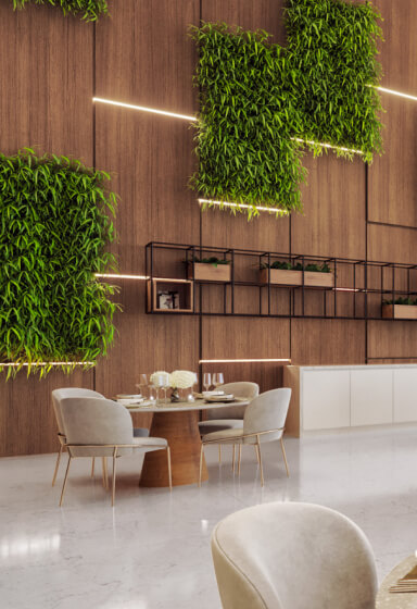 Detalhes do Salão de Festas do condomínio com parede revestida em madeira e decoração refinada com ramos de folhas naturais integrando o ambiente.